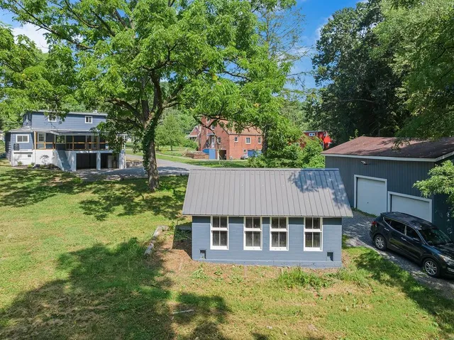 an aerial view of a house with a yard table and chairs