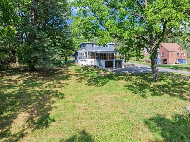 a view of a house with a yard