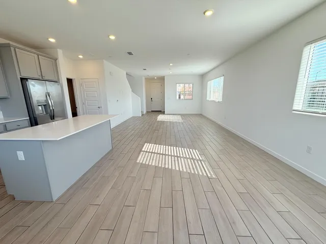 a view of a room with wooden floor and a window