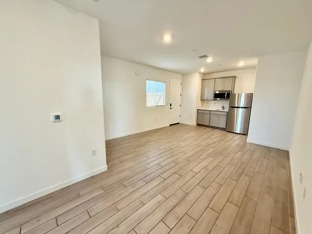 a view of a kitchen with wooden floor and a sink