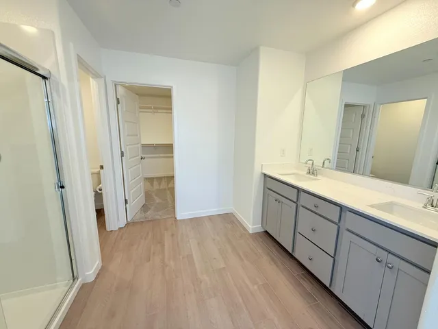 a bathroom with a double vanity sink and mirror
