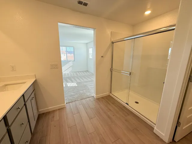 a bathroom with a shower and a sink