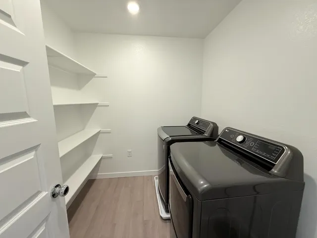 a bathroom with a sink double vanity granite tub shower and a mirror