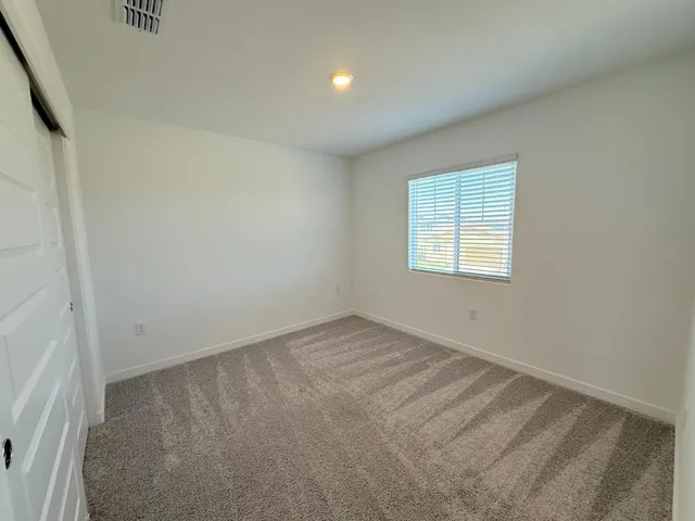 a view of backyard with wooden fence