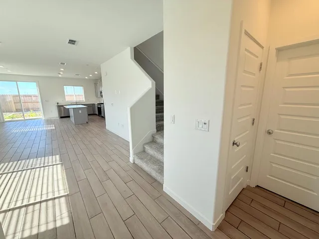 a view of a hallway view with floor to ceiling window and wooden floor