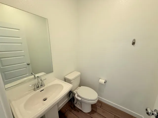 a bathroom with a sink a toilet and mirror