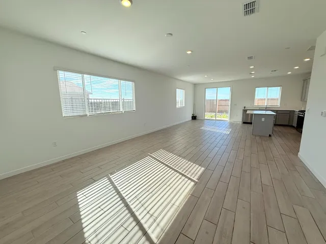 a living room with a couch and wooden floor