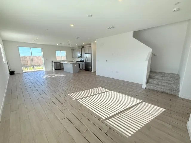 a view of kitchen and hall with wooden floor