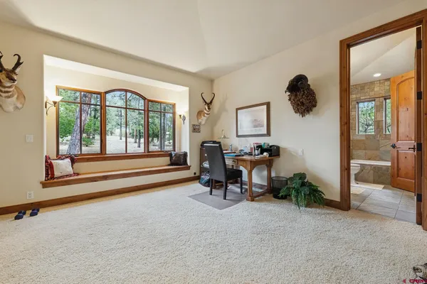 a large kitchen with stainless steel appliances a large counter top a stove a chimney a sink and a large window
