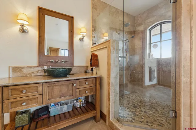 a bathroom with a sink a mirror and a shower