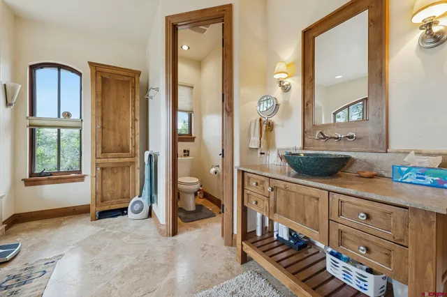 a bathroom with a tub a double vanity sink a mirror and a shower