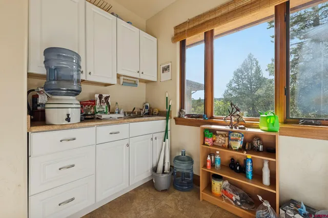 a kitchen with stainless steel appliances a sink and a large window