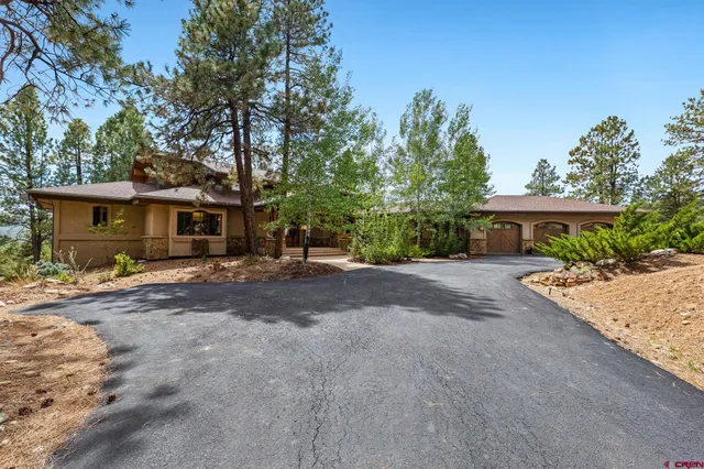 a view of a house with a yard and tree s