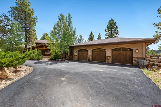 a big house with a yard and large trees