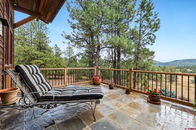 a view of a two chairs in the balcony