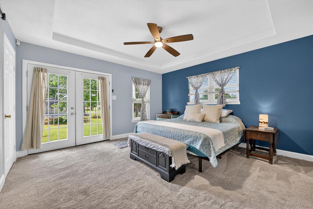 1808 Silver Creek Azle Road Azle, TX 76020 - Photo 17 of 32 a spacious bedroom with a bed and a large window