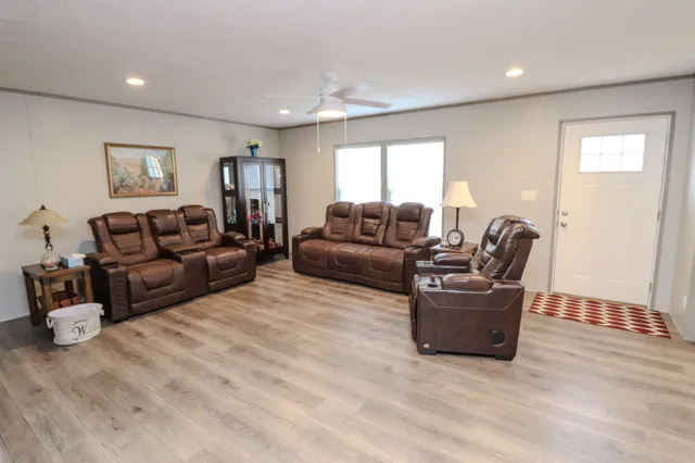 a living room with white cabinets and a fireplace