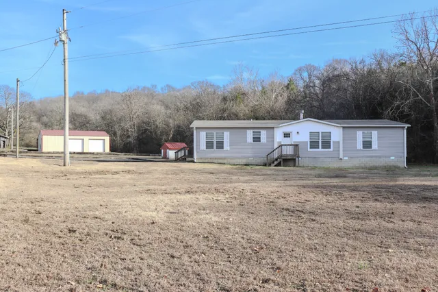 a view of a house with a backyard