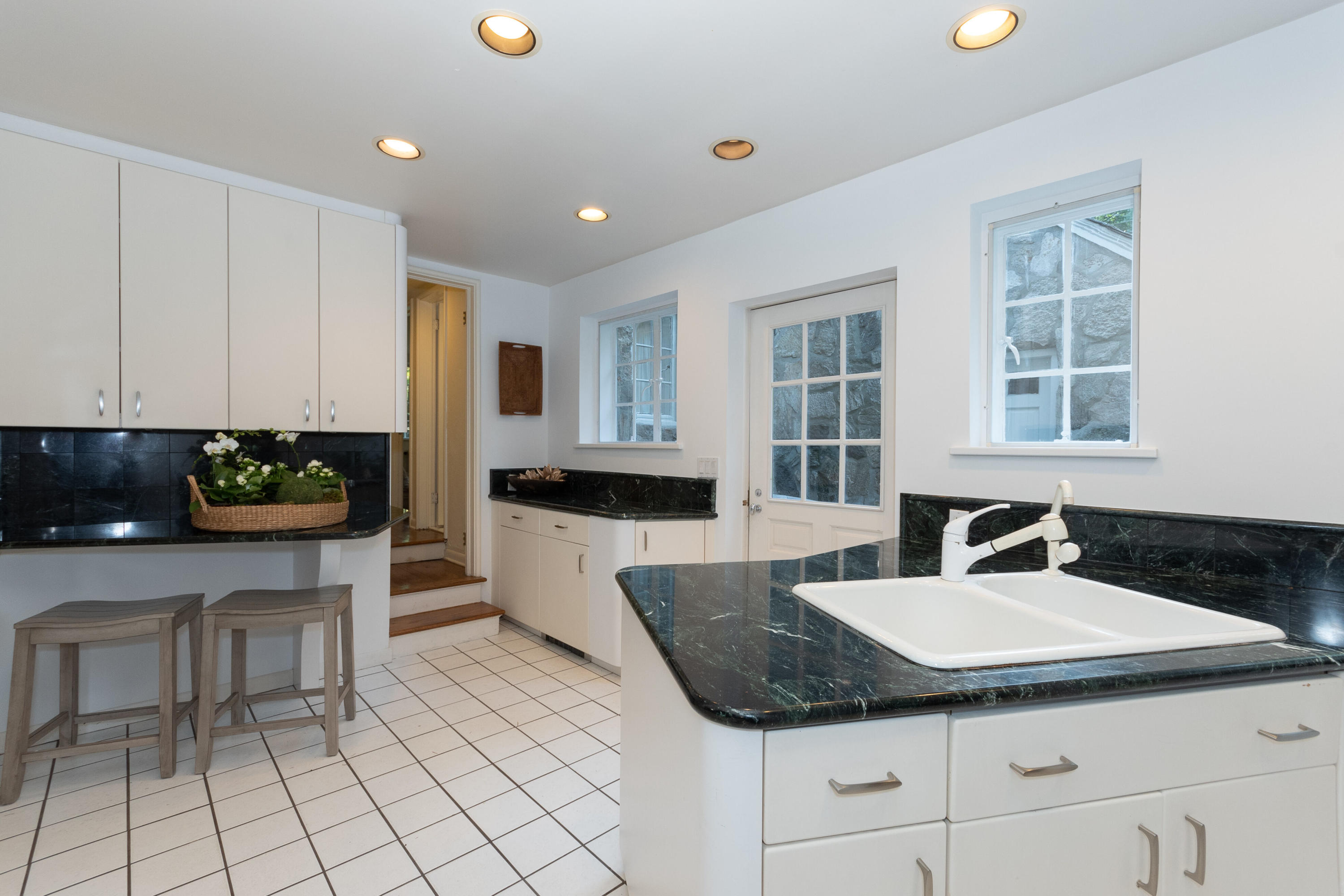11 Searles Road Darien, CT 06820 - Photo 14 of 43 a kitchen with granite countertop a sink and white cabinets