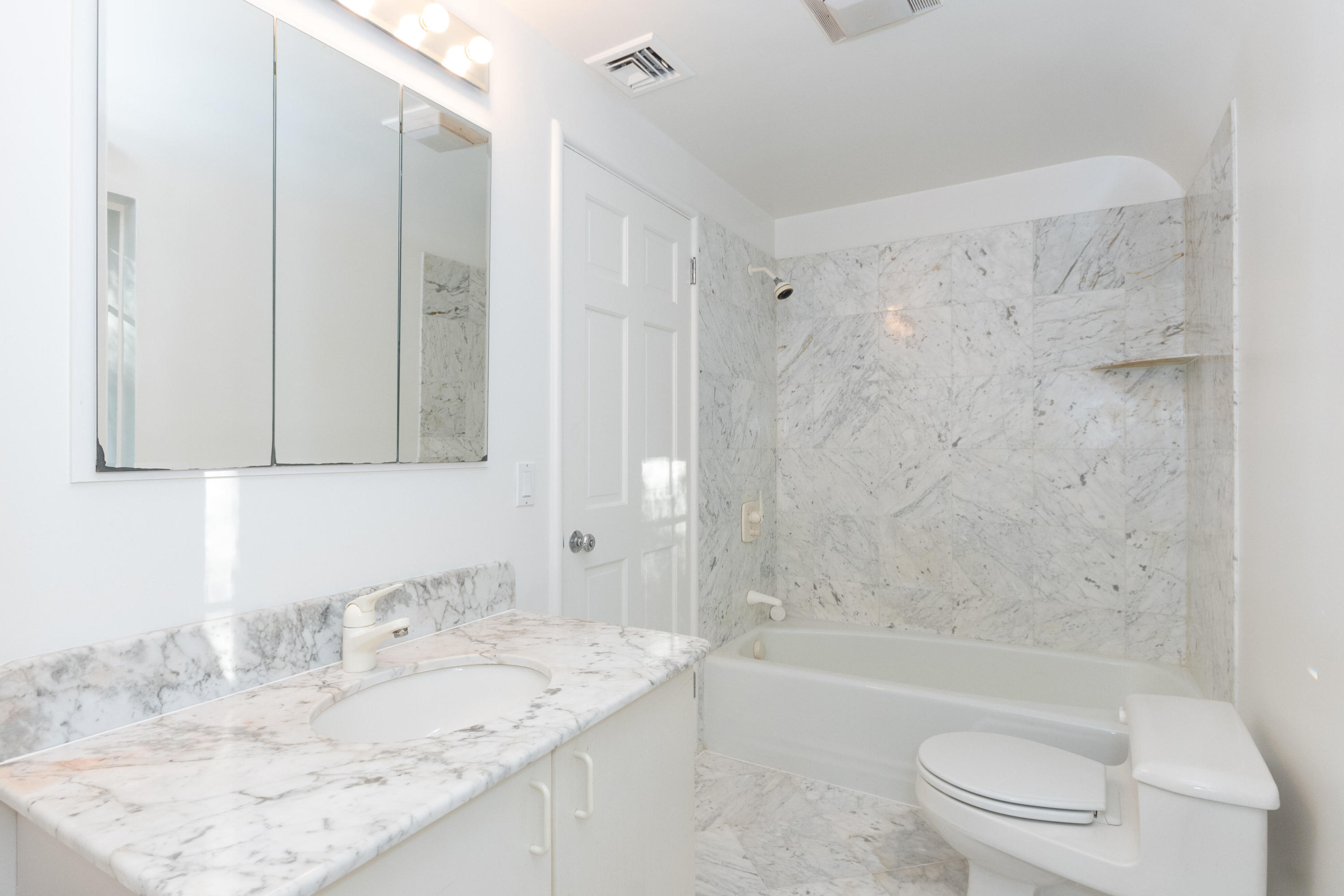 11 Searles Road Darien, CT 06820 - Photo 29 of 43 a bathroom with a granite countertop sink and a mirror