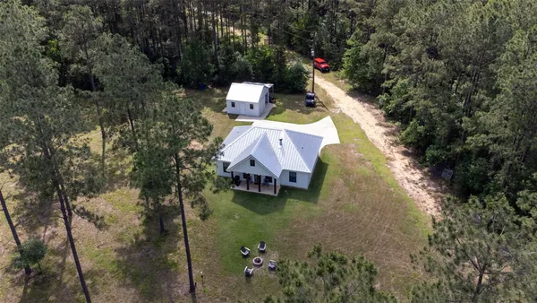 a view of a house with a yard and sitting area