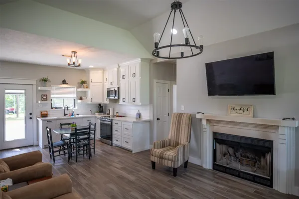 a view of a livingroom with furniture and a flat screen tv