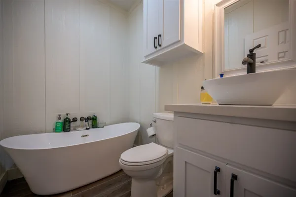a white toilet sitting next to a white sink