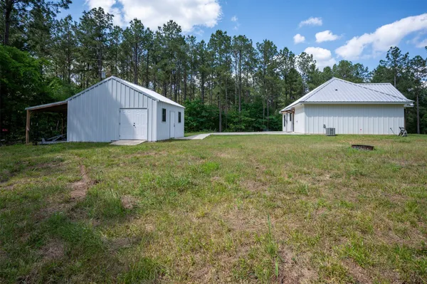a view of a small house with backyard