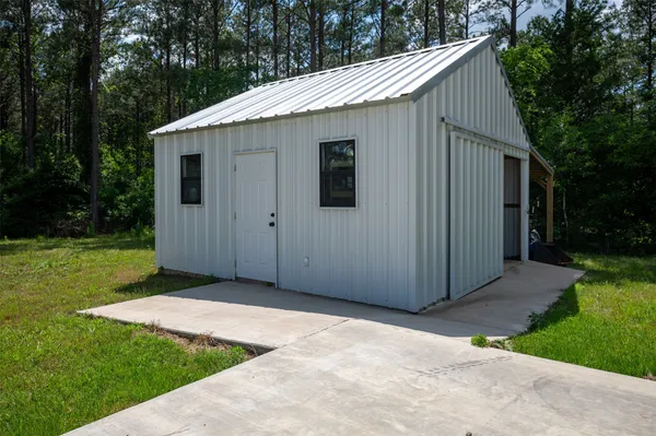 a backyard of a house with table and chairs