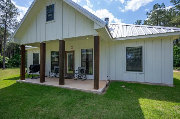 a view of an house with backyard porch and furniture