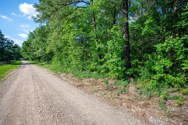an aerial view of a house with a yard and parking space