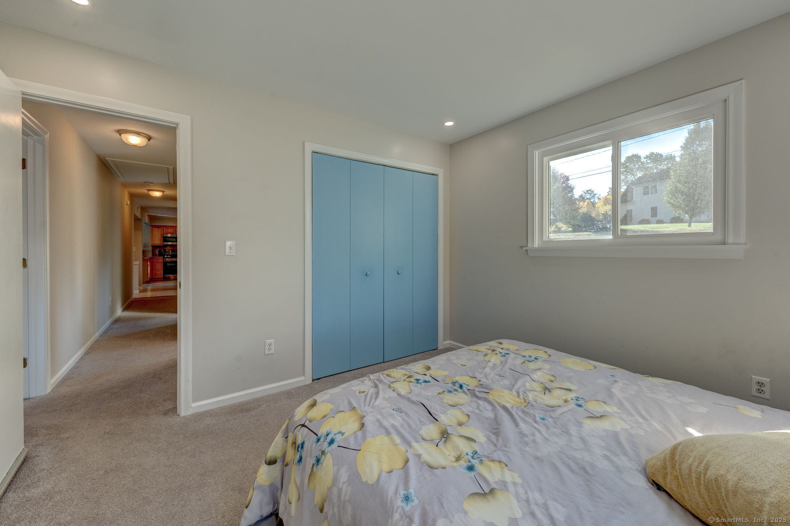 a bedroom with a bed and a window