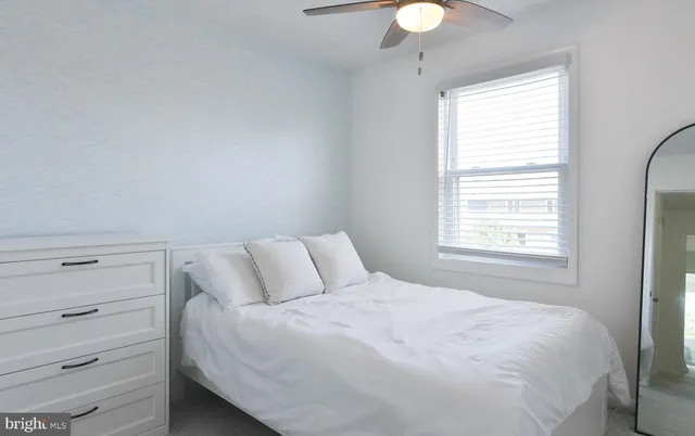 a bedroom with a bed and a night stand