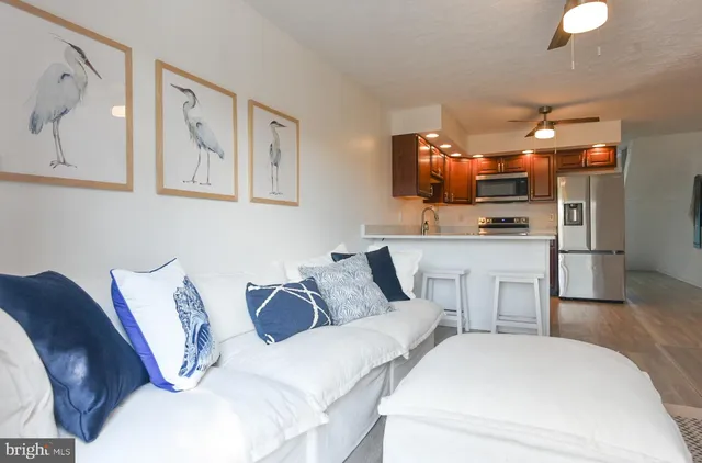 a living room with furniture and painting on the wall