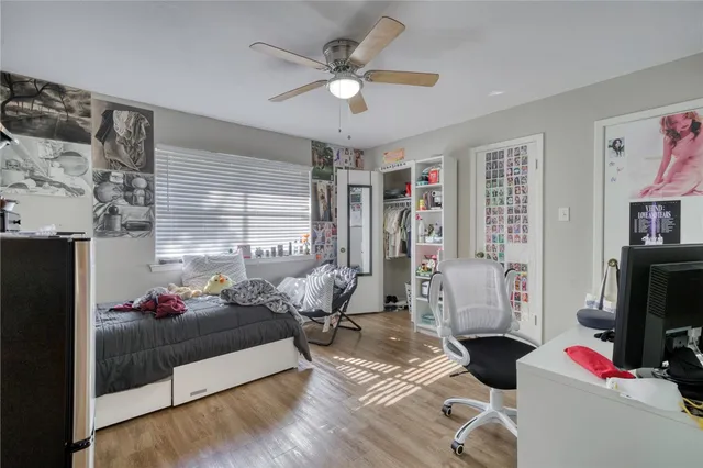 a living room with furniture gym equipment and a flat screen tv