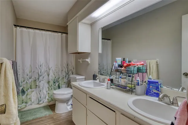 a bathroom with a sink toilet and shower
