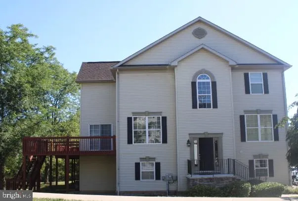 a front view of a house with plants