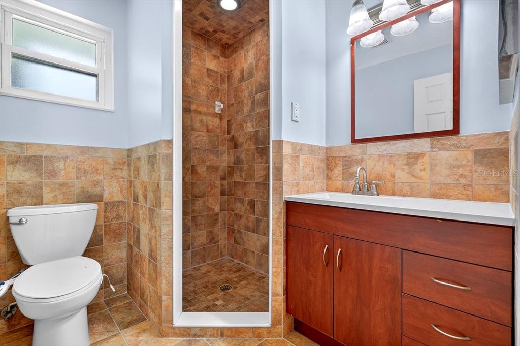 1309 Suwanee Road Daytona Beach, FL 32114 - Photo 15 of 33 a bathroom with a toilet sink and mirror
