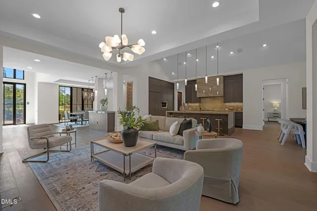 a kitchen with stainless steel appliances granite countertop a sink a stove and a wooden floors