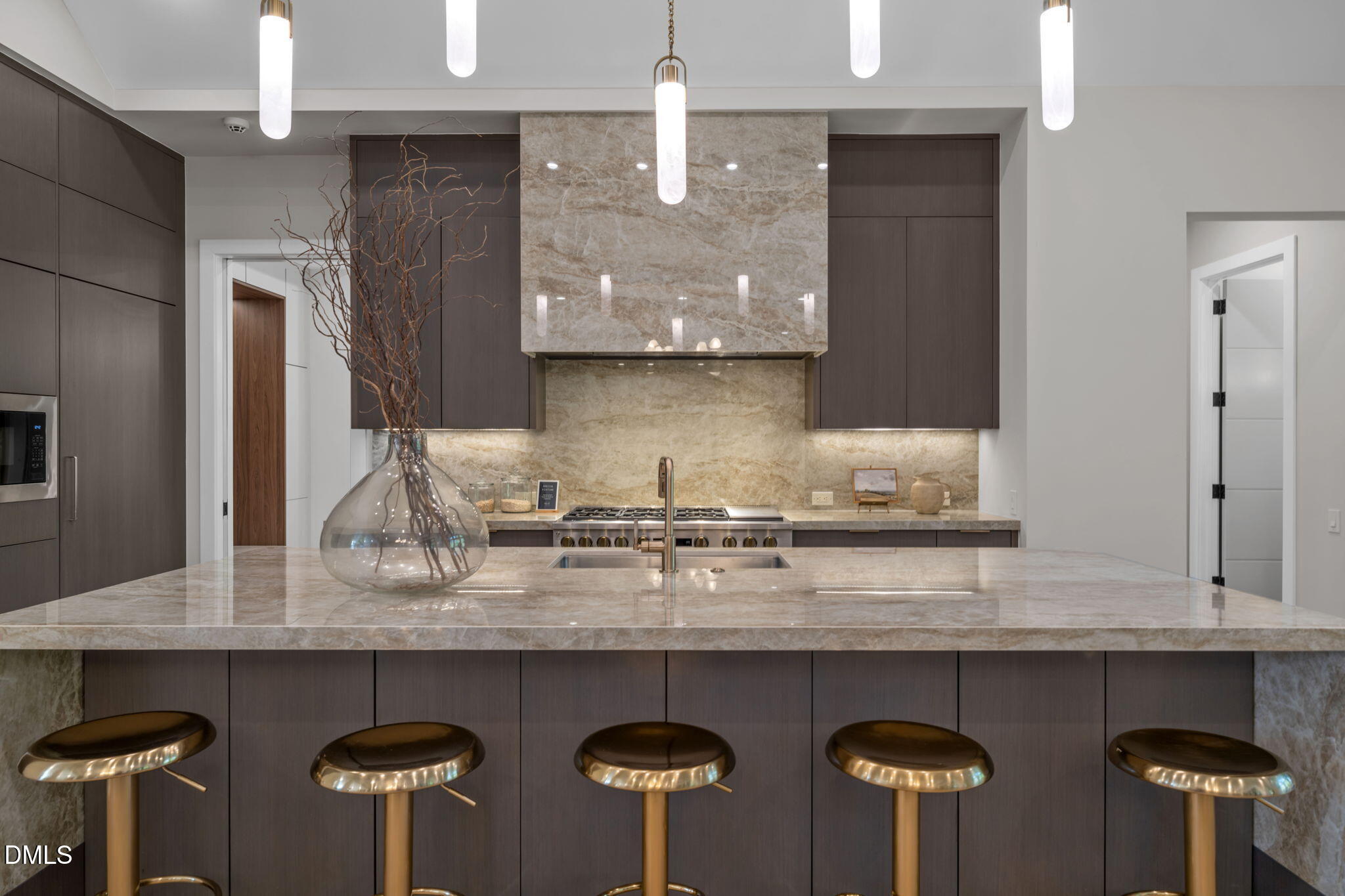 504 Colvard Woods Way Durham, NC 27713 - Photo 27 of 77 a kitchen with stainless steel appliances granite countertop a table chairs in it and wooden floors