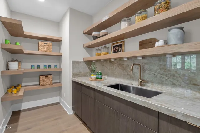 a bed sitting in a spacious bedroom next to a window