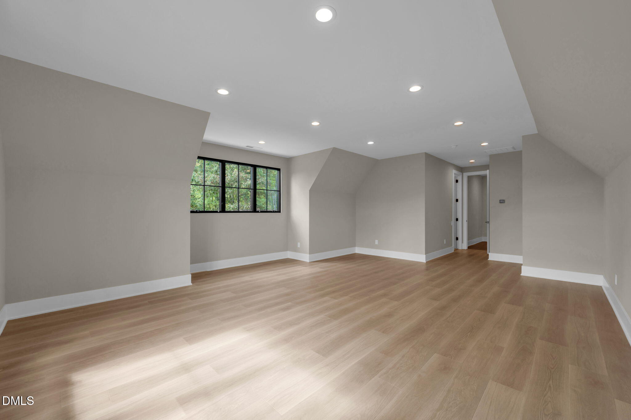 504 Colvard Woods Way Durham, NC 27713 - Photo 68 of 77 a view of an empty room with wooden floor and windows