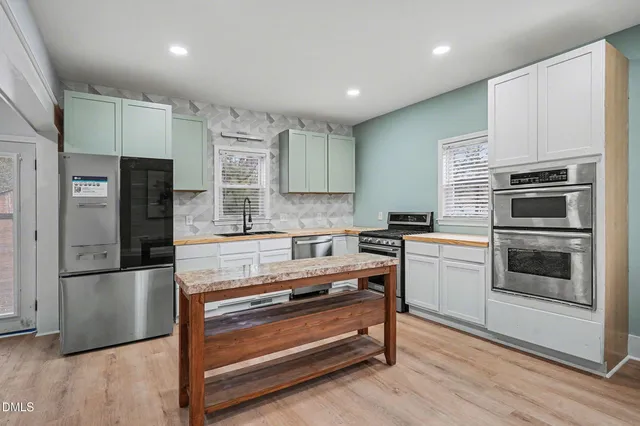 a kitchen with a refrigerator stove and microwave