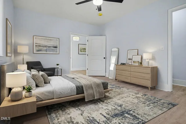 a bedroom with a bed a couch and a chandelier