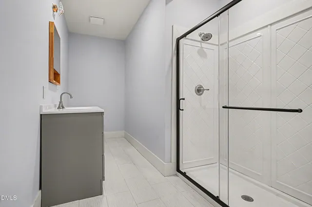 a bathroom with a shower and a sink