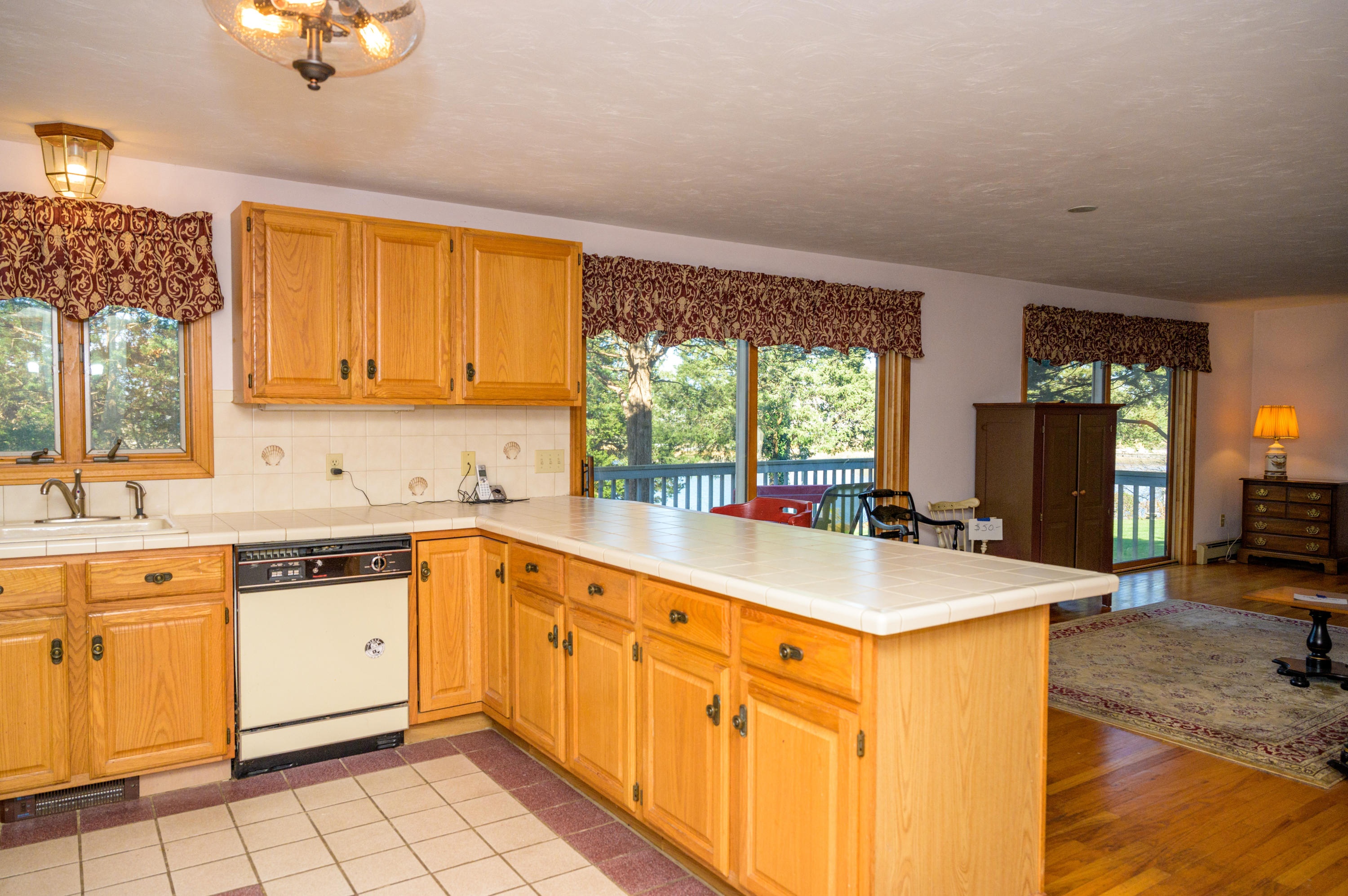 18 Warren Road Bourne, MA 02532 - Photo 14 of 36 a kitchen with stainless steel appliances granite countertop a sink and cabinets