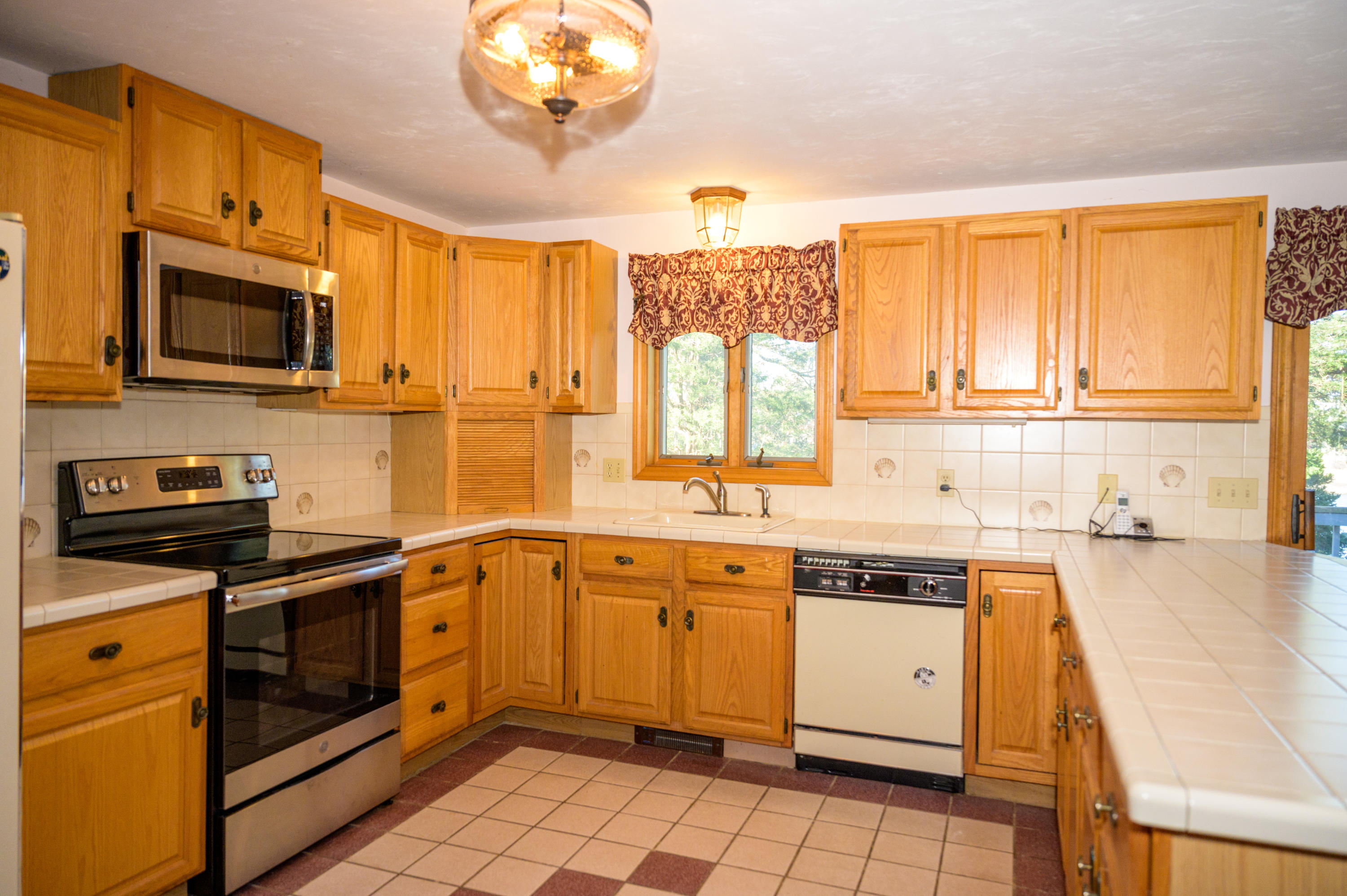 18 Warren Road Bourne, MA 02532 - Photo 16 of 36 a kitchen that has a sink and a stove top oven