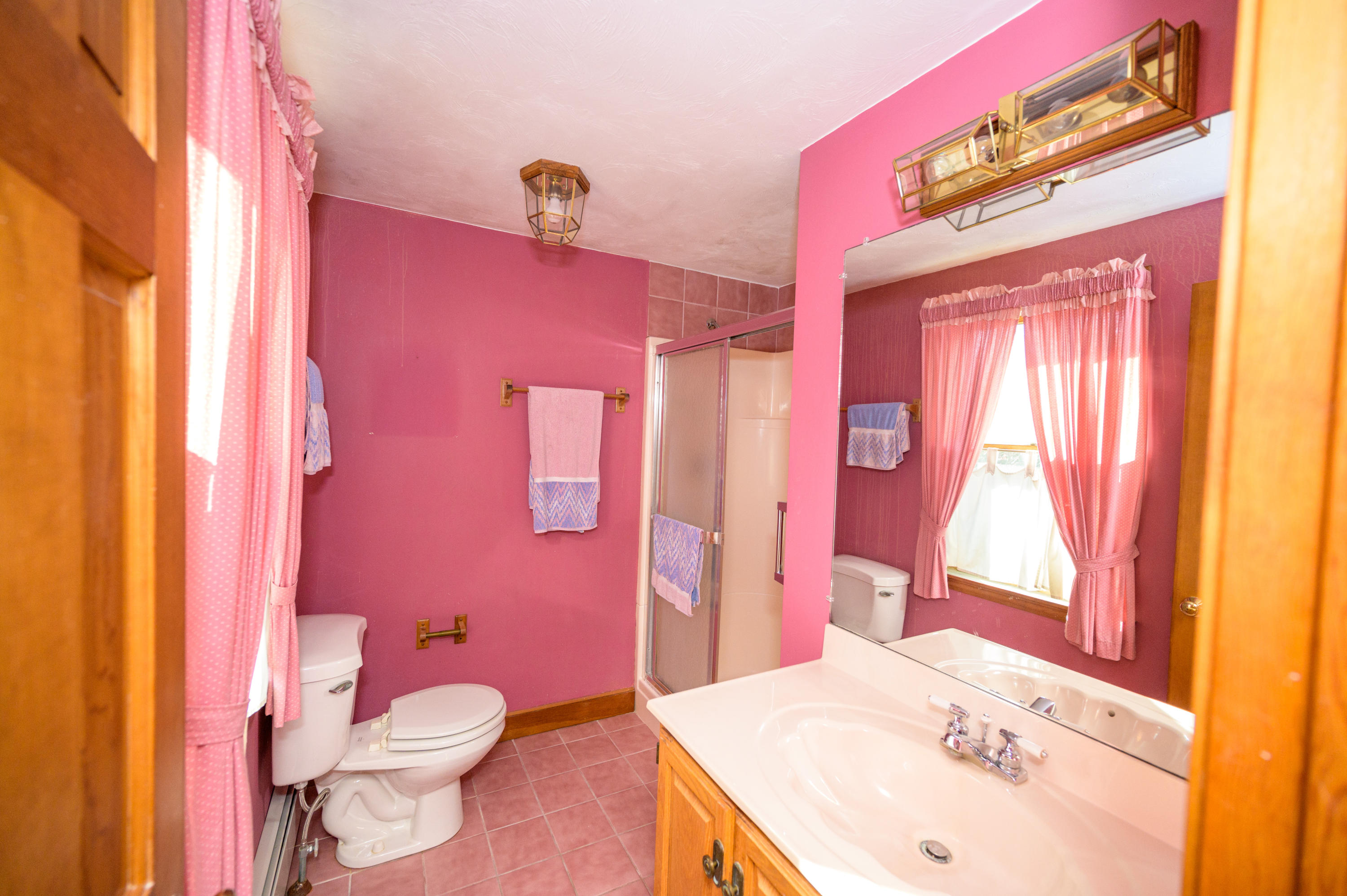 18 Warren Road Bourne, MA 02532 - Photo 24 of 36 a bathroom with a sink a toilet a mirror and vanity