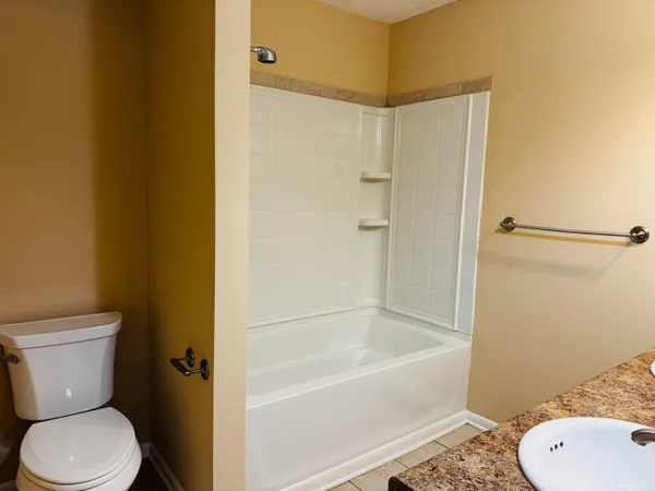 a bathroom with a toilet and a bathtub