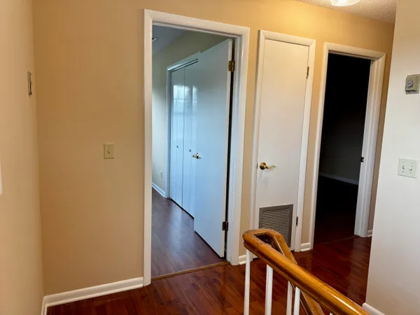 a view of wooden floor and a chandelier in a room